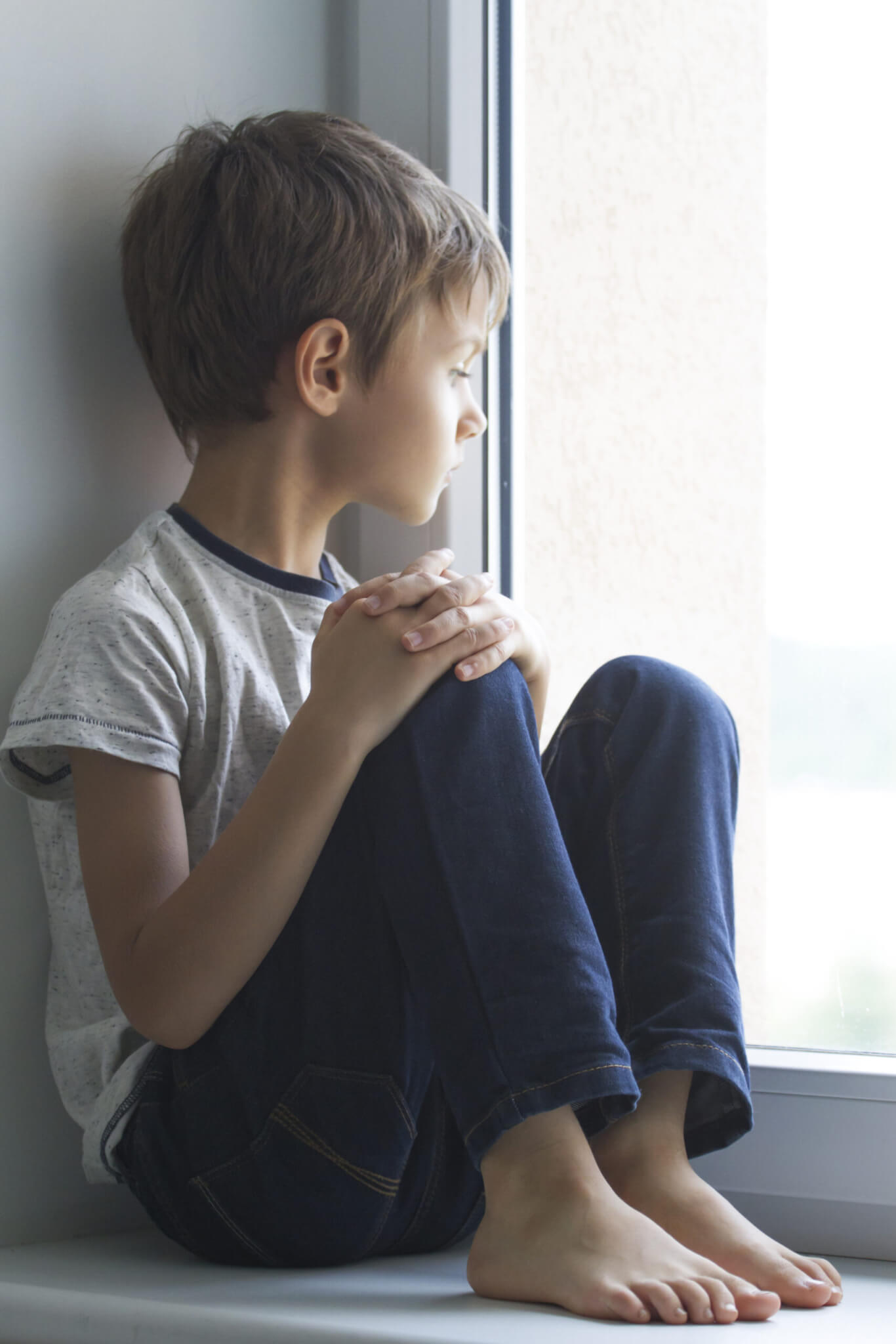 melancholy child looking out window
